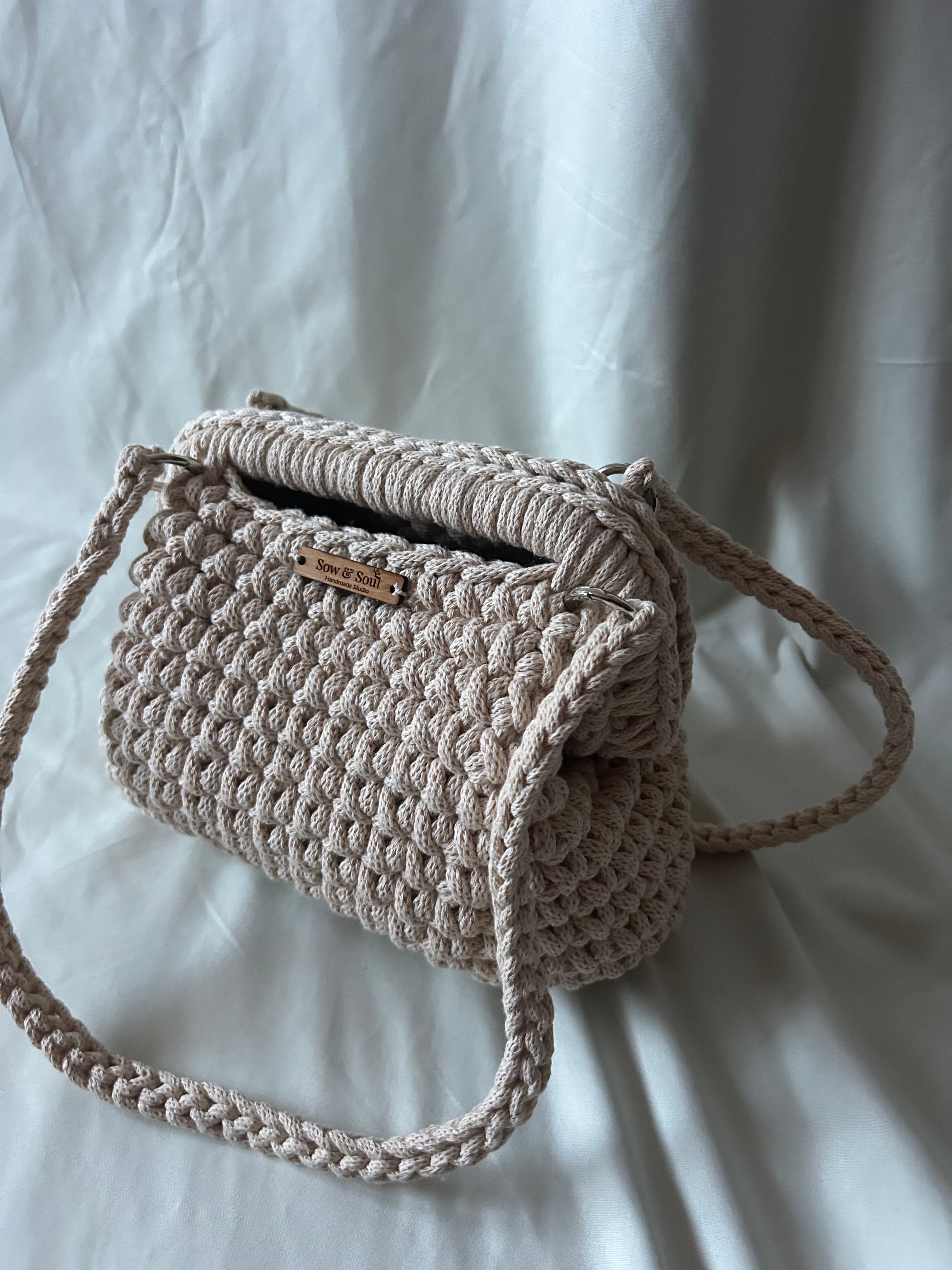 Woven handbag with a strap on a light background